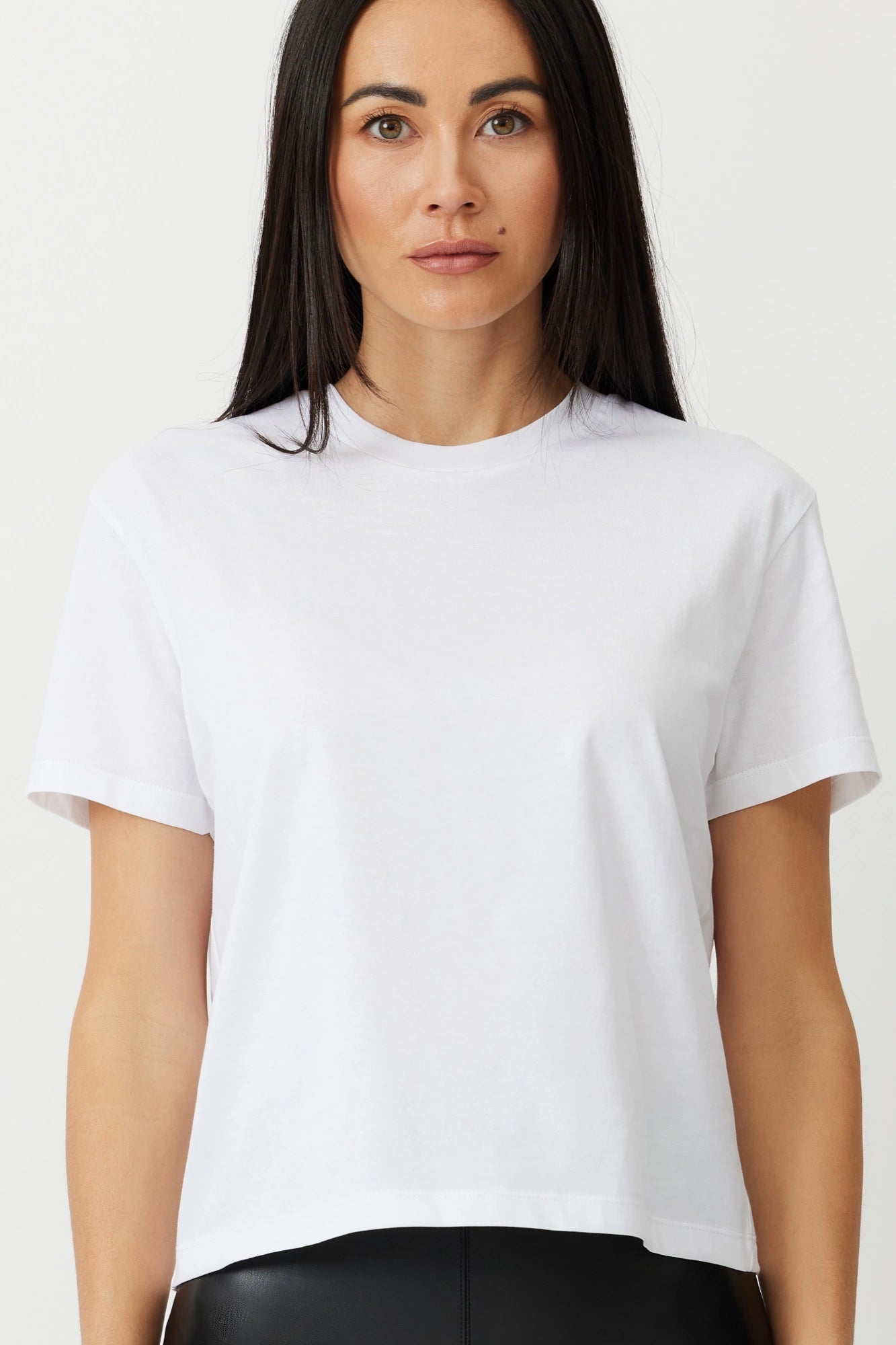 Model wearing a white box tee The Aiton by Greyven