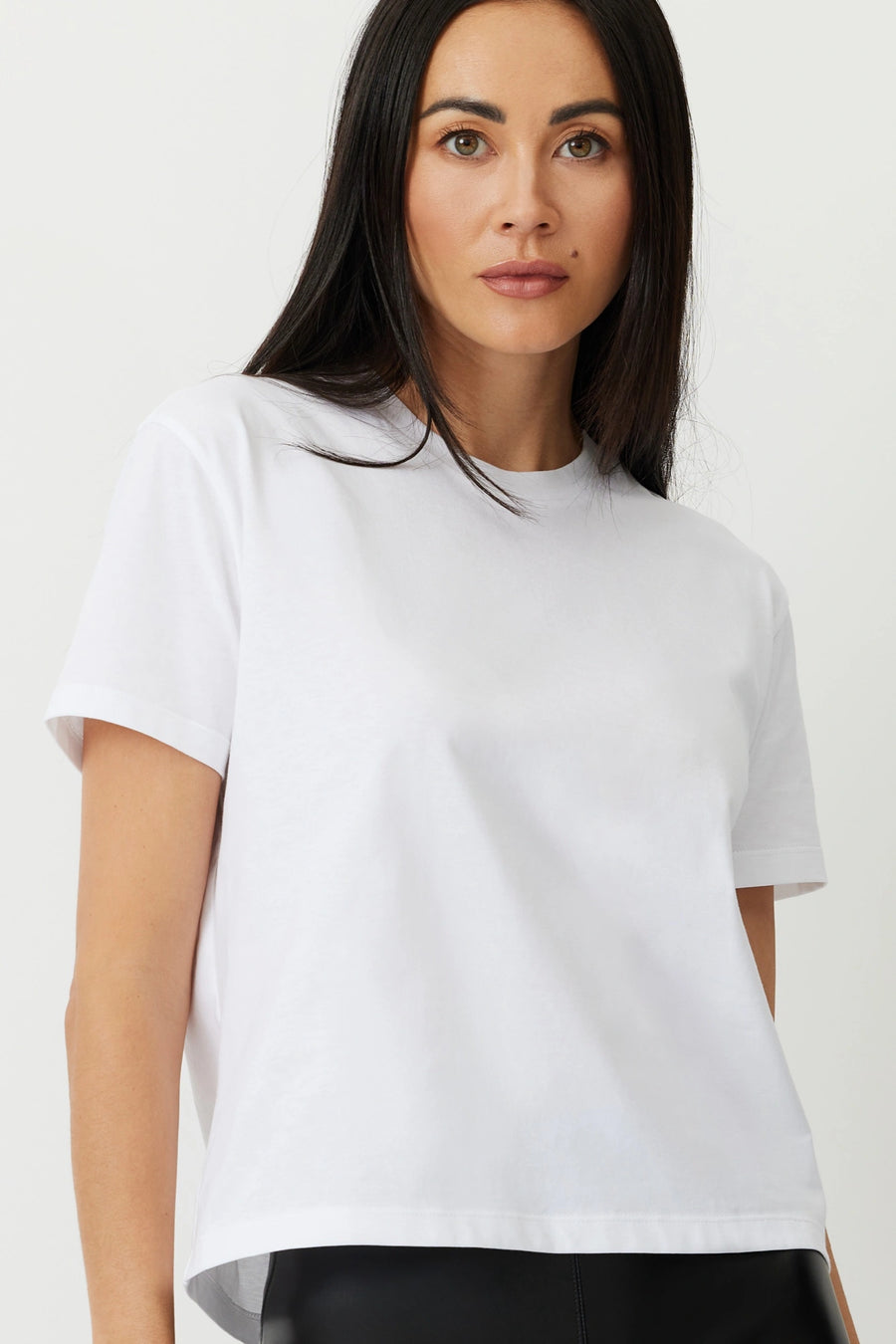 Model wearing a white box tee The Aiton by Greyven