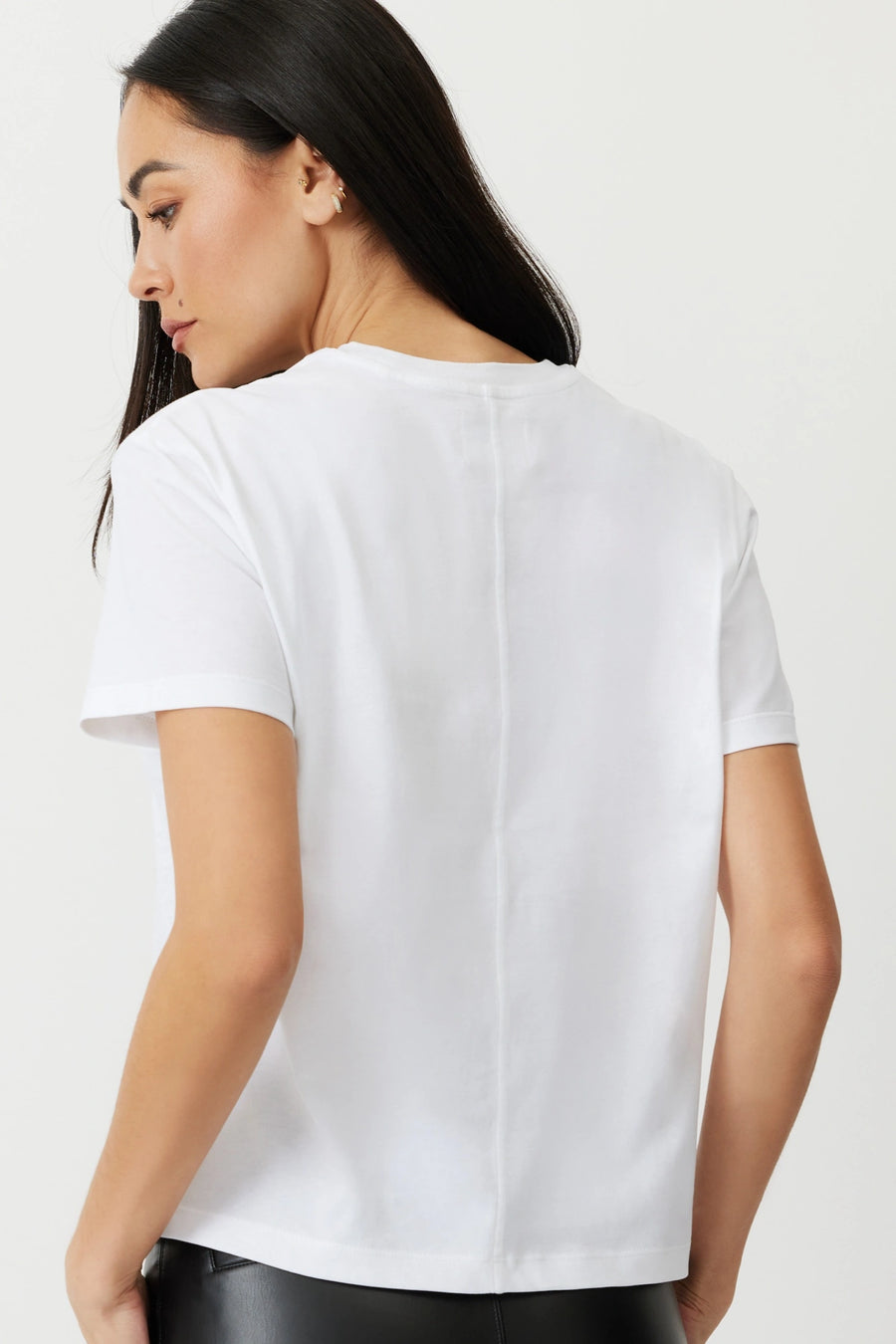 Model wearing a white box tee The Aiton by Greyven