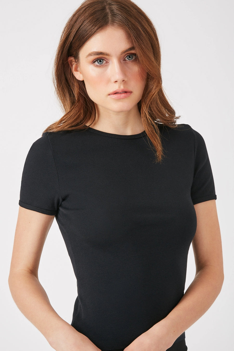 Model wearing a black cap sleeve tee The Baillie by Greyven