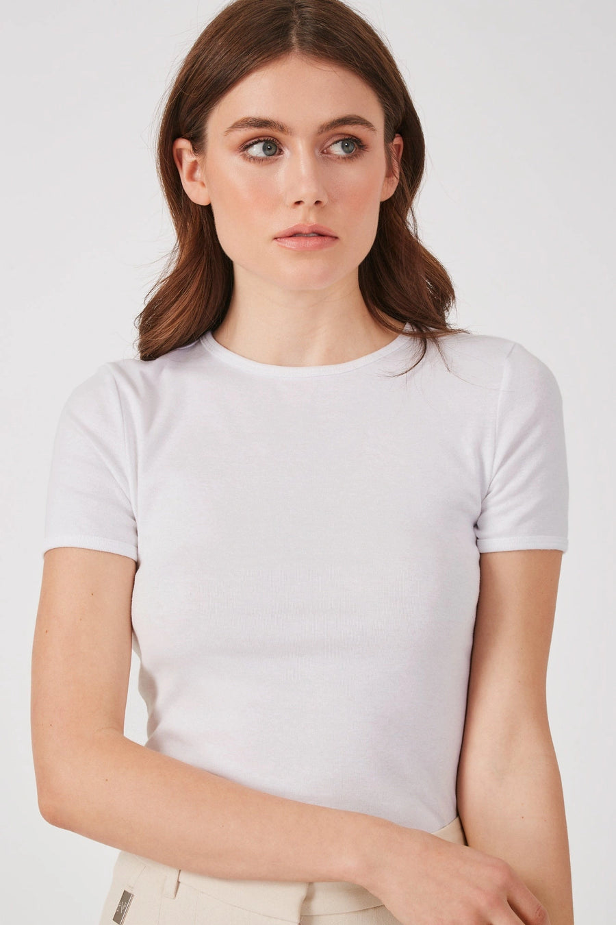 Model wearing a white cap sleeve tee The Baillie by Greyven
