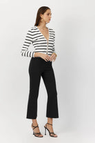 Model wearing the Breton Stripe Gemma Ribbed Knit Cardigan, illustrating its classic stripe pattern and elegant fit.