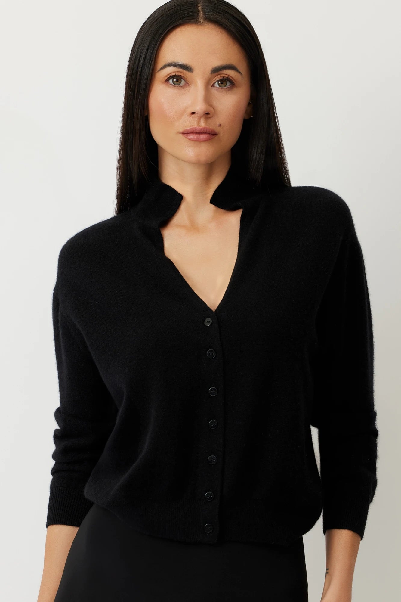 Model wearing THE LAUREN SHRUNKEN CASHMERE CARDIGAN in Black, showcasing its classic design and luxurious, ethically sourced cashmere.