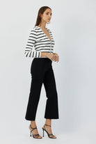 The Porterfield crop nip tuck flare pants in black by Greyven.