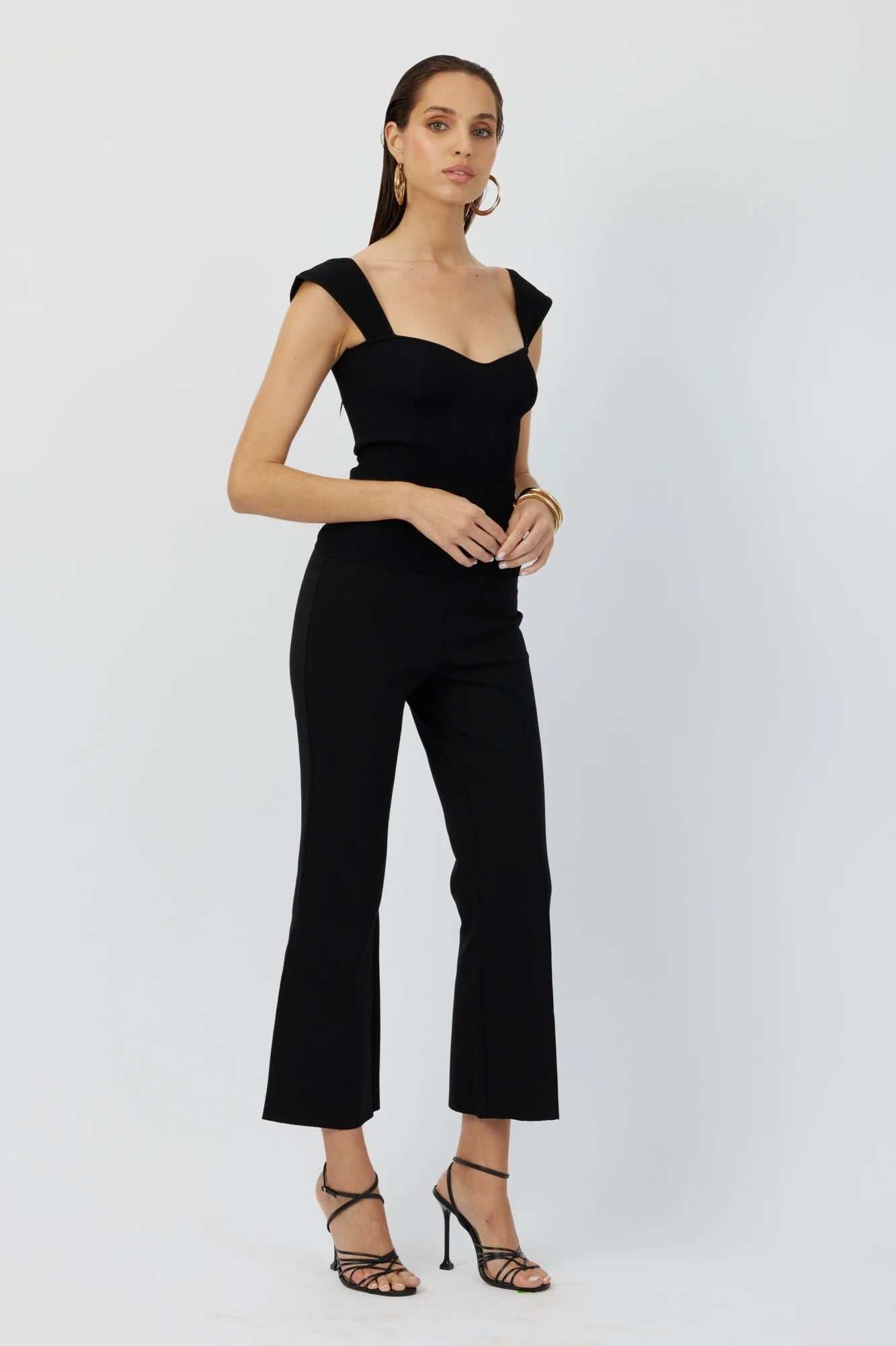 The Porterfield crop nip tuck flare pants in black by Greyven.