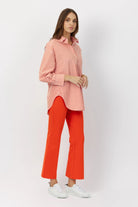 The Porterfield crop nip tuck flare pants in orange crush by Greyven